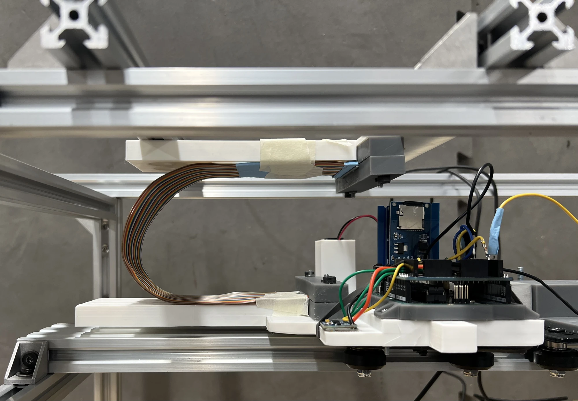 Close-up of the built rolling-loop fixture, moving carriage, and onboard electronics.